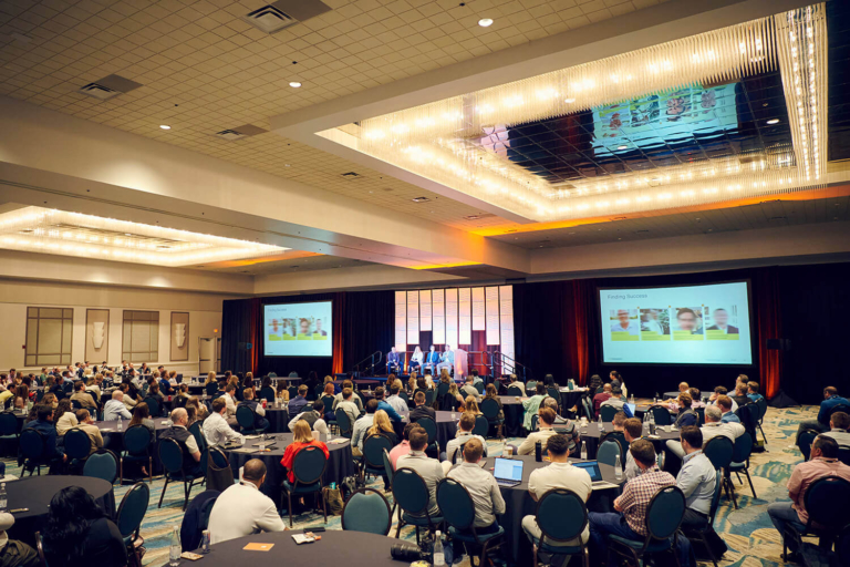 Wide view of a hotel ballroom during a corporate conference in Orlando